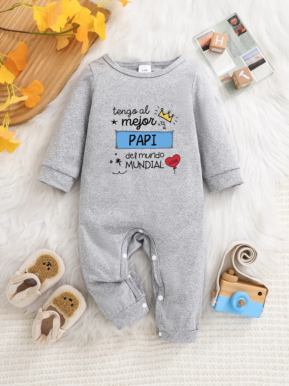 A baby long-sleeved onesie with interesting letter prints. It features a buttoned design for easy putting on and taking off, and