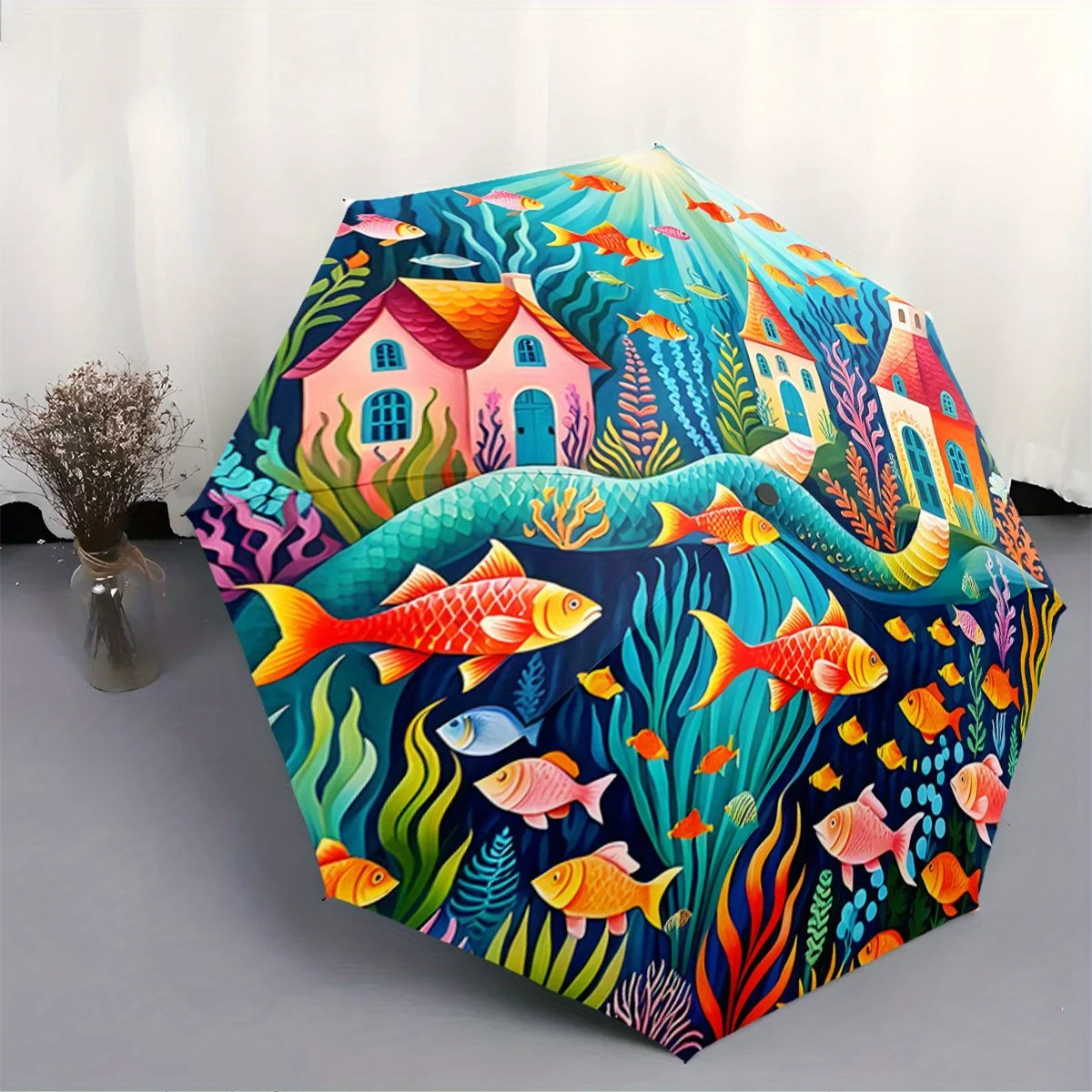 

Automatic Folding Umbrella The umbrella features an underwater scene with colorful fish and coral. Portable collapsible design