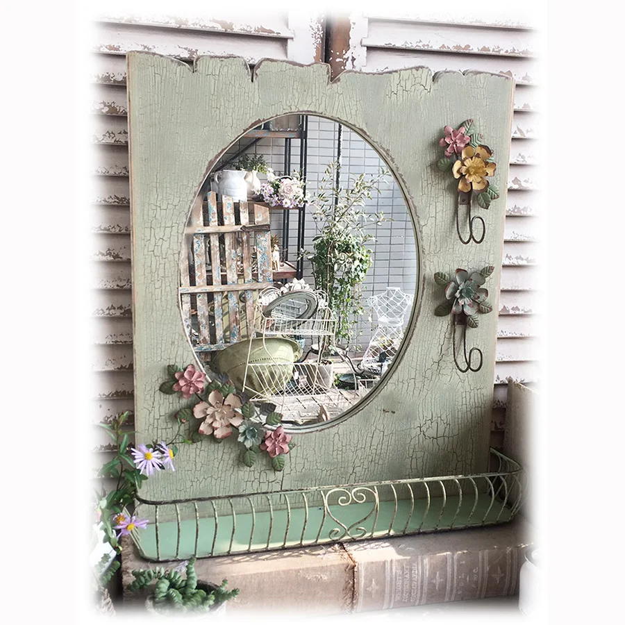 

Antique Oval Mirror with Vintage Wood Frame, Floating Shelf, and Decorative Iron Flower Accent