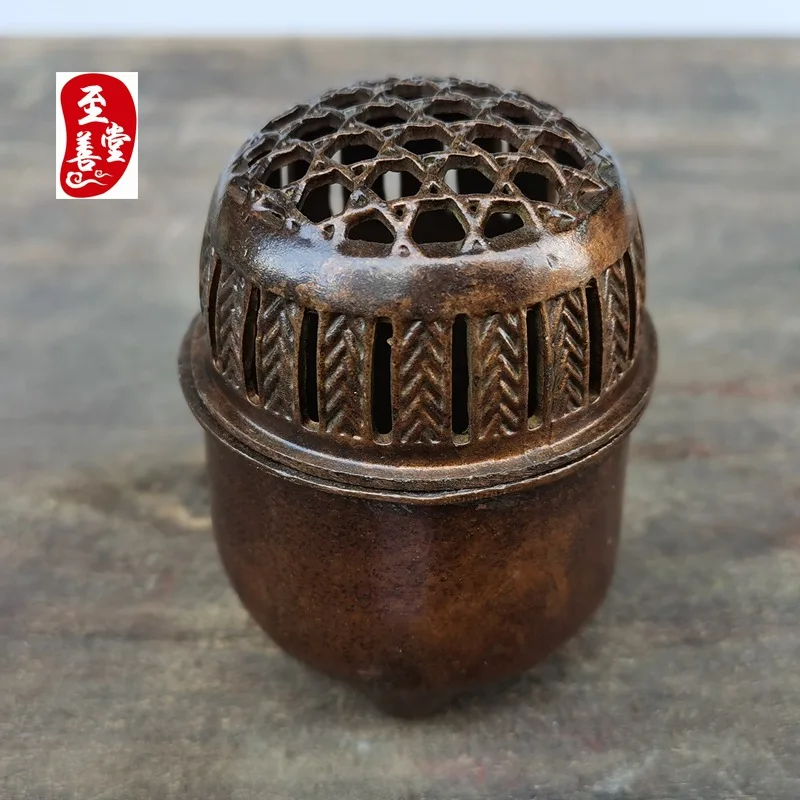 Antique-style copper alloy incense burner with a patina effect, designed for living room decoration, featuring a round, openwork