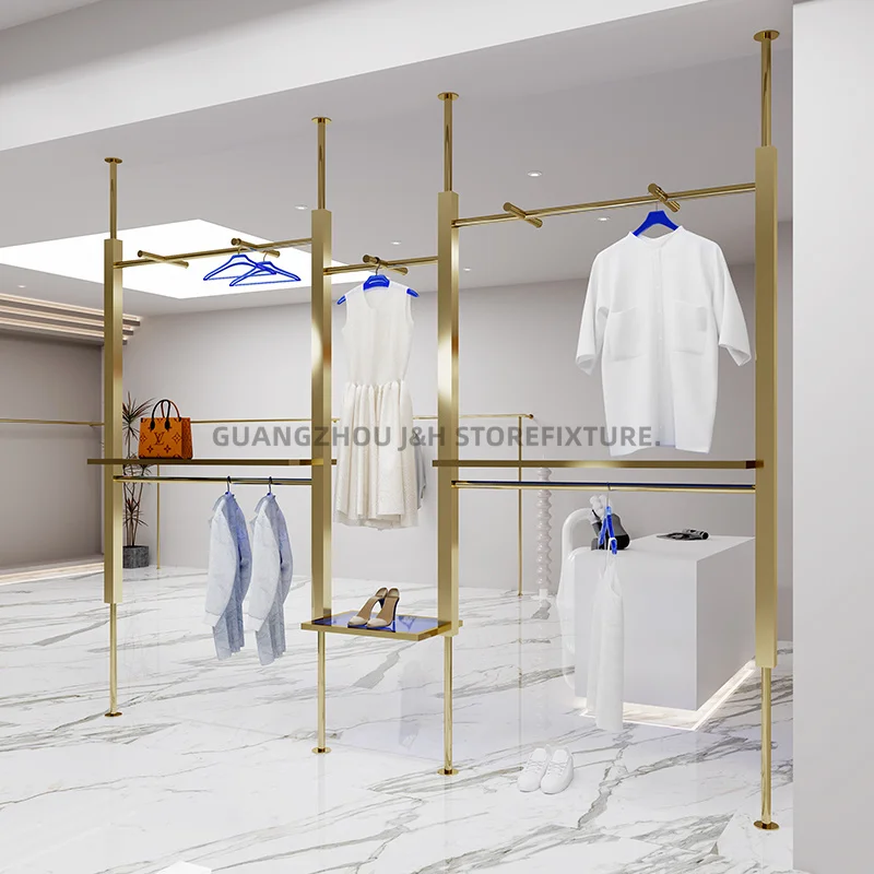 ราวแขวนเสื้อผ้าติดผนังแบบกำหนดเอง สำหรับร้านขายเสื้อผ้าผู้หญิง ทำจากสแตนเลสสตีลสีทองไทเทเนียม