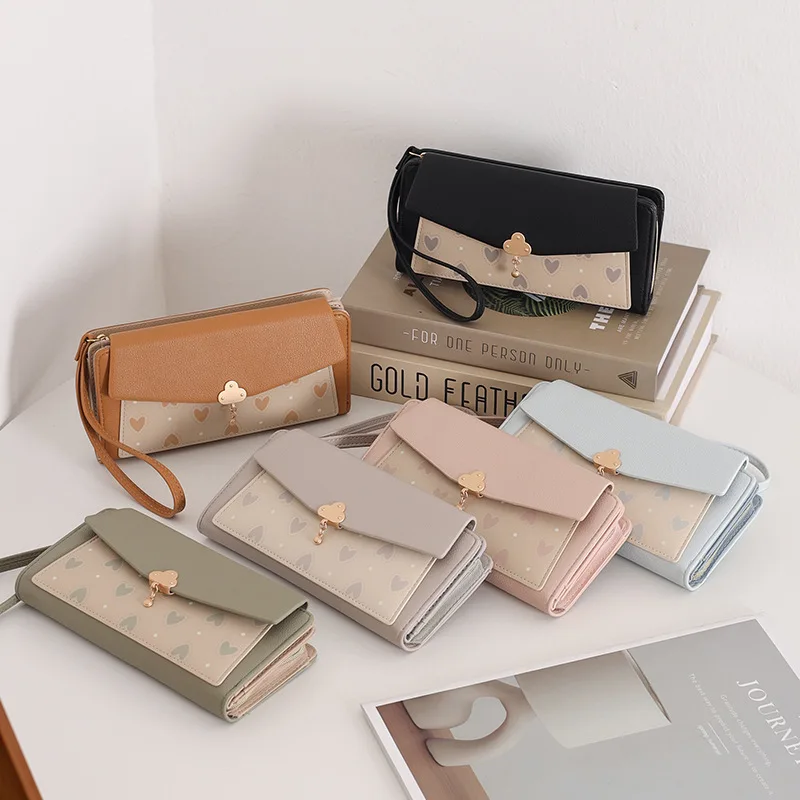 

PU leather ladies' long wallet, heart-shaped printed zipper, hardware pendant, hand-held large-capacity travel wallet