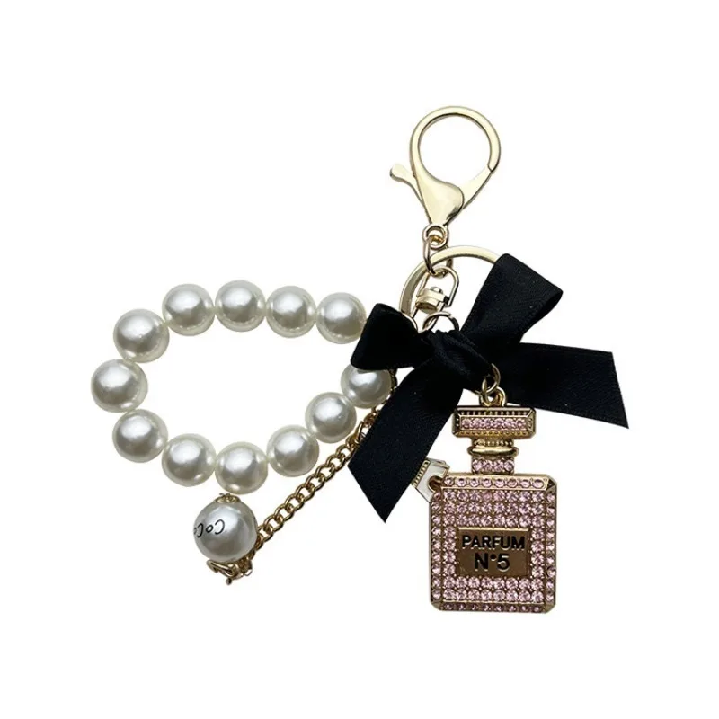 Alloy diamond inlaid bow shaped perfume bottle key chain creative pearl chain bag pendant exquisite key chain image 5