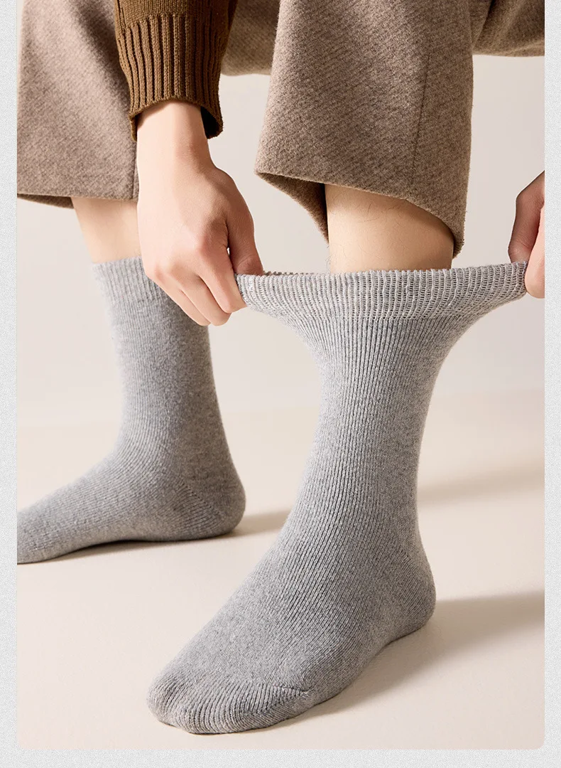 Calcetines de lana de invierno grises para hombres con tejido acanalado y una superficie de textura suave, mostrados desde el lado posterior.