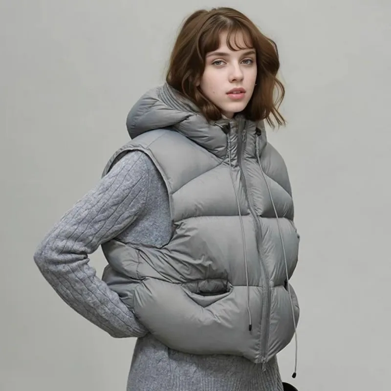 เสื้อกั๊กขนเป็ดแบบมีฮู้ดสำหรับฤดูใบไม้ร่วงและฤดูหนาว ทรงหลวม หนานุ่ม อุ่นสบาย เหมาะสำหรับผู้หญิง สีขาว ซิปหน้า ไม่มีแขน