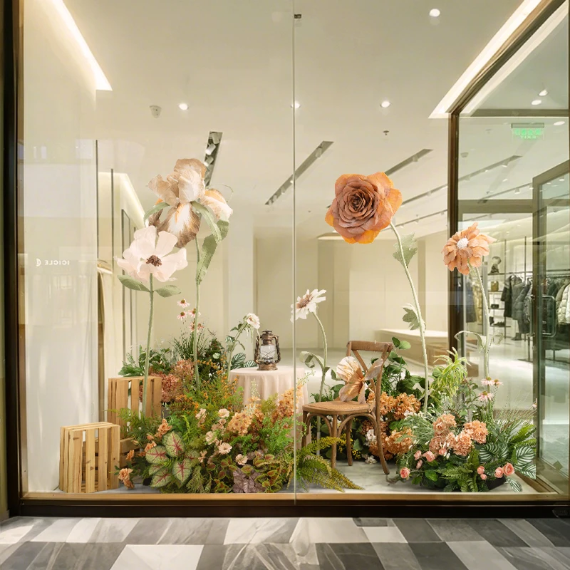 Photo floral scene arrangement large paper flower green plant landscaping Internet celebrity clock in the background