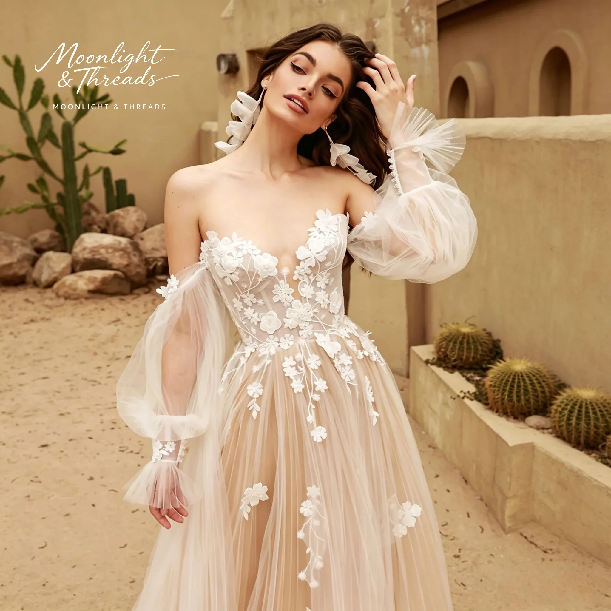 

Ivory embroidered tulle strapless A-line floor-length formal wedding gown featuring appliqué embroidery and matching sleeves