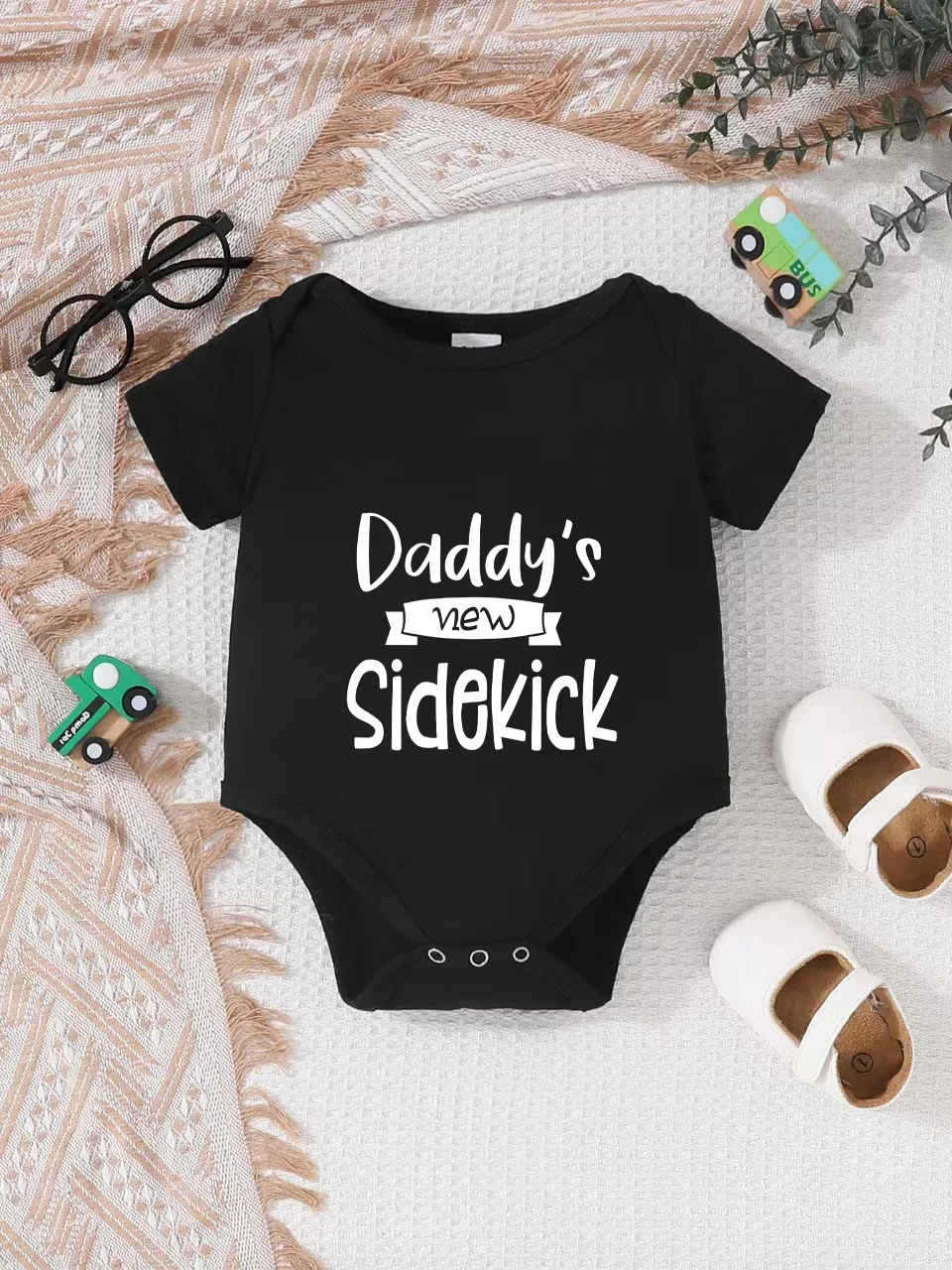 Playful letter-printed baby short-sleeve triangle bodysuit. Button closure for easy dressing