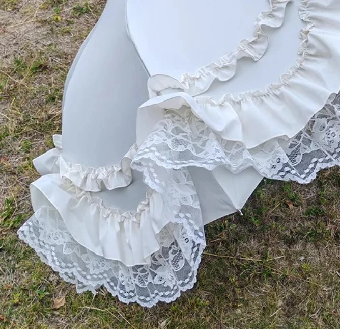 A Focal Point of Vintage Elegance: Arched Birdcage Parasol Adorned with Delicate Lace.