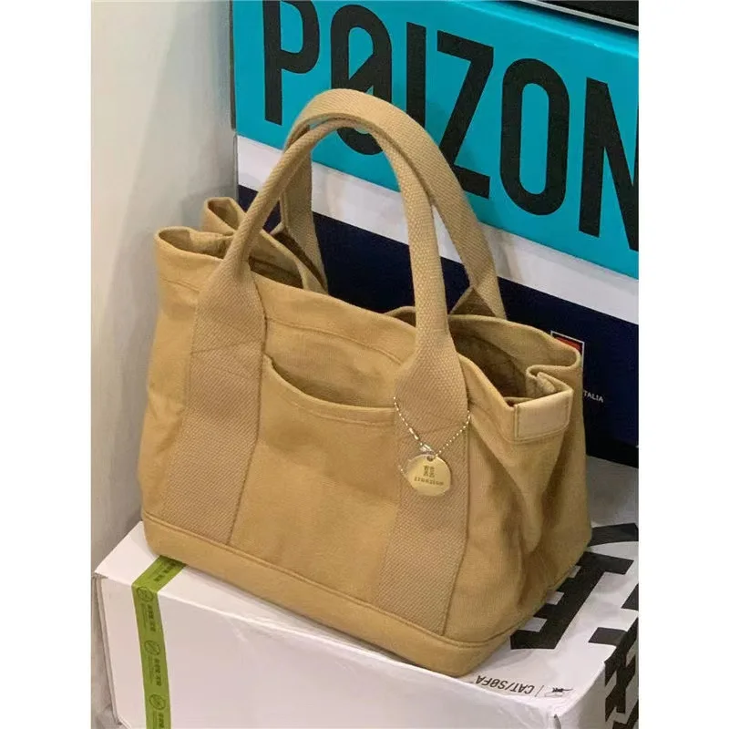 Bolso de hombro Retro versátil para mujer, bolso de mano de lona con diseño de nicho Premium, a la moda