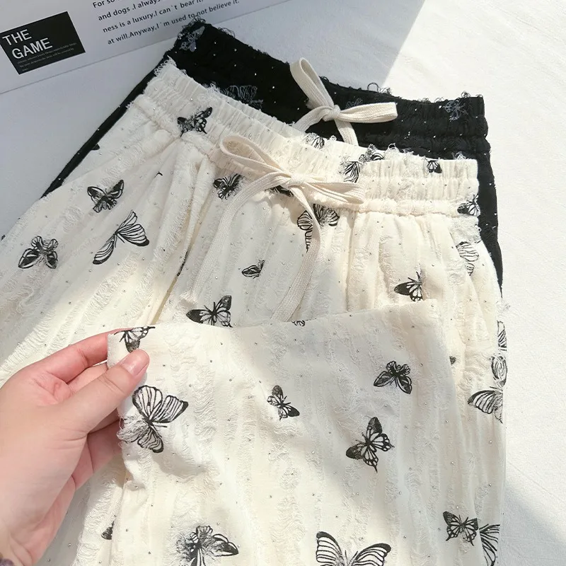 Nuovi pantaloni a gamba larga a farfalla in stile cinese Pantaloni a gamba dritta bianchi larghi e pigri a vita alta di nuovo stile estivo femminile con fori