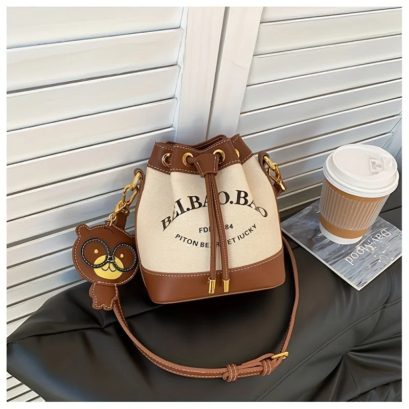 Chic Canvas Bucket Bag with Letter Design - Crossbody & Shoulder Style with Pendant, Drawstring Closure for Everyday Use