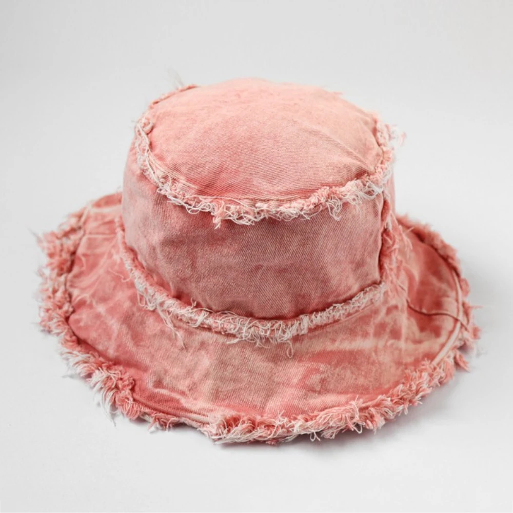 Japanese-style vintage water-washed fringed boater hat distressed and bleached with torn brim and wide brimmed denim bucket hat