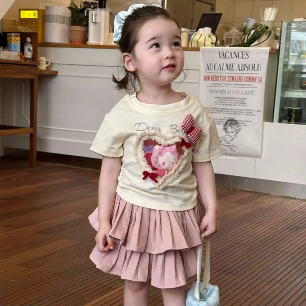 

Sanrio Kawaii Cake Skirt Hellokitty 2025 Children's Fashionable Bow Cartoon Short-Sleeved Top Girls Pleated Skirt Two-Piece Set