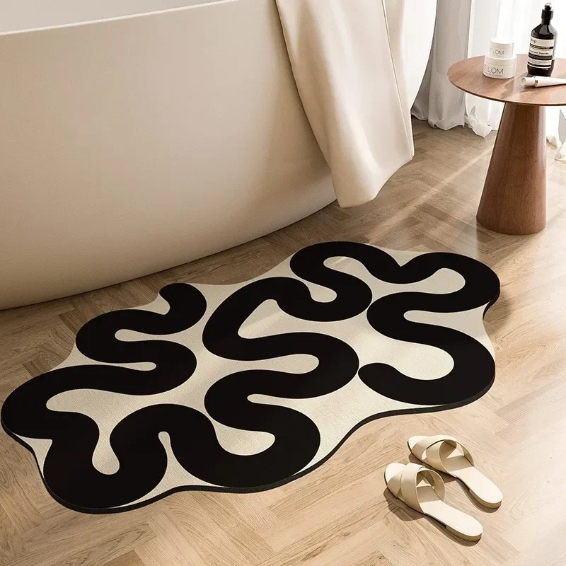 Black and white irregular absorbent floor mat at the bathroom door, bathroom toilet, anti slip quick drying diatomaceous earth