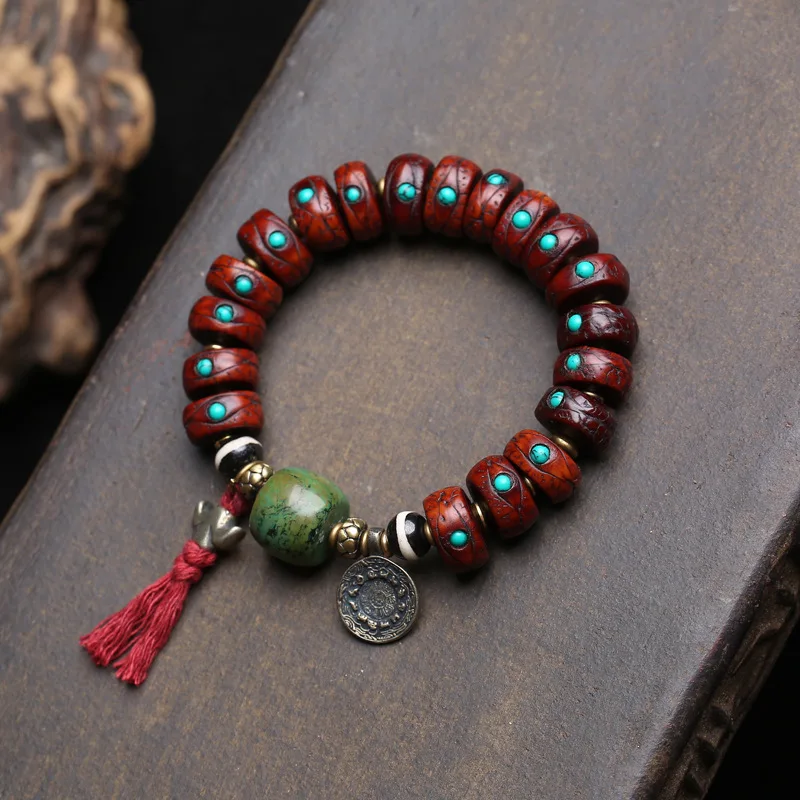 

Single-strand Tibetan-style cultural artefact bracelet featuring natural phoenix-eye bodhi seeds, turquoise, and shidolin bone