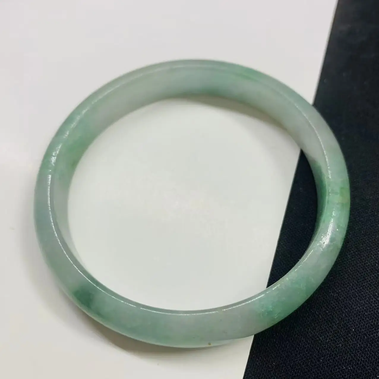 

Light green 58.8mm floating flower jade bracelet, photographed in real life