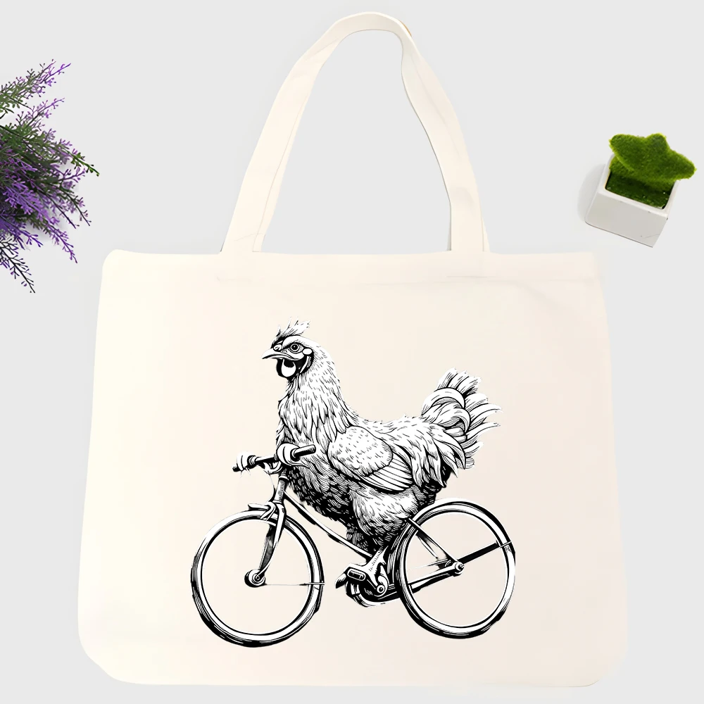 Unisex chicken riding bicycle graphic canvas tote bag, casual style for daily shopping and weekend outings