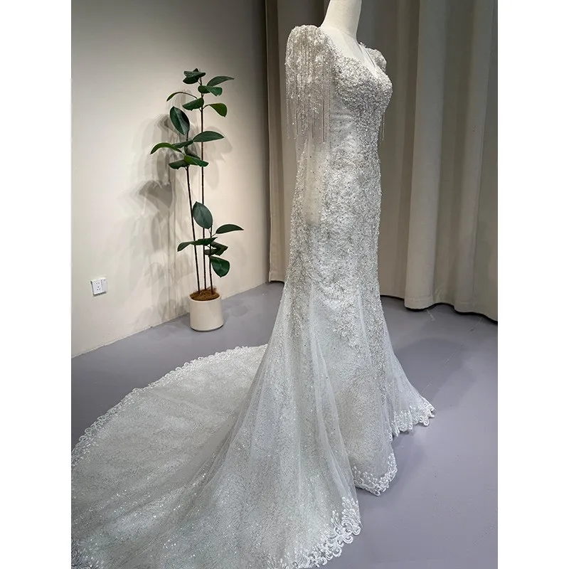 

A new luxurious heavily handcrafted short-sleeved lace dress with light tulle fishtail and main