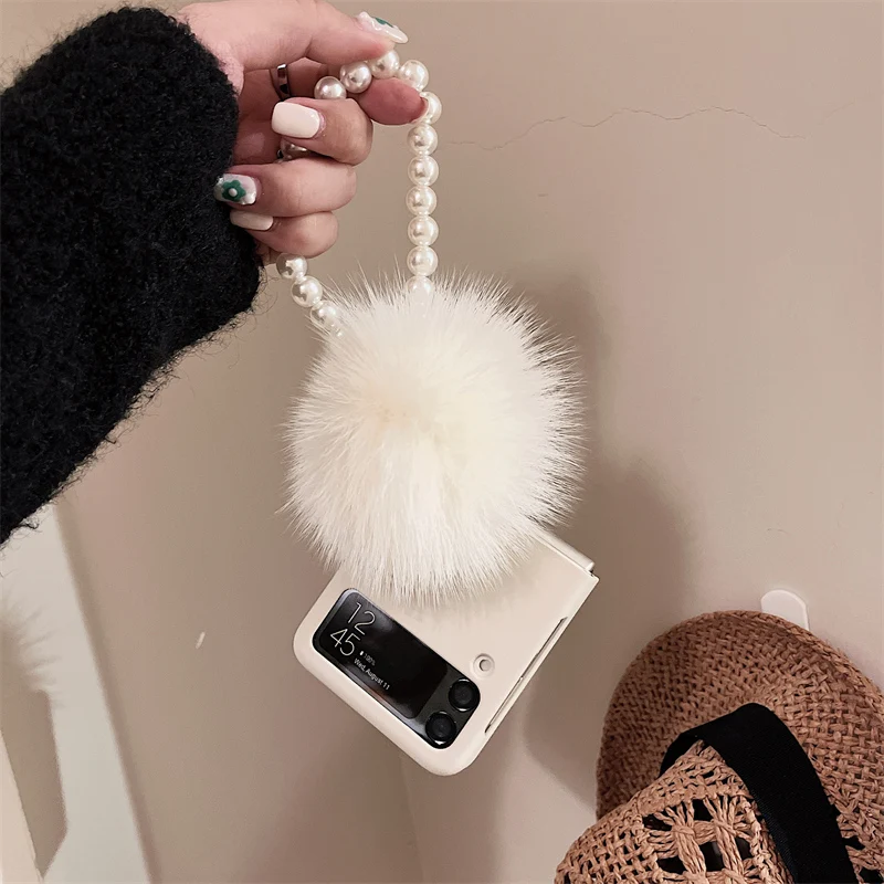 

Fashion Cute Fur Ball Pendant Portable Pearl Hand Chain Shockproof Skin Case Cover For Samsung Galaxy Z Flip 4 3 Flip3 Flip4 5G