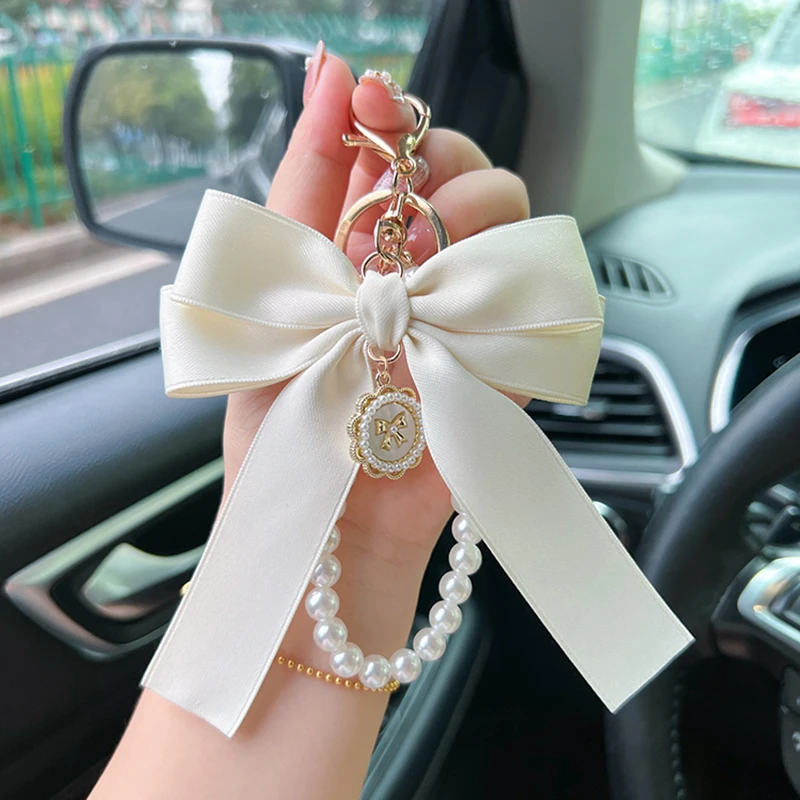 Porte-clés avec nœud créatif et perle, pendentif de sac à la mode pour femmes, porte-clés de voiture, cravate de présidence à ruban personnalisé