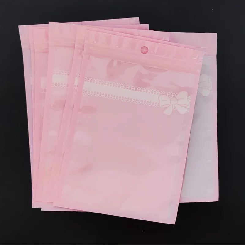 

100PCS Pink Plastic Bow Ziplock Bags Clear Resealable Jewelry Pouches for DIYCosmetics Nails Beauty Puffs Gift Packaging Storage