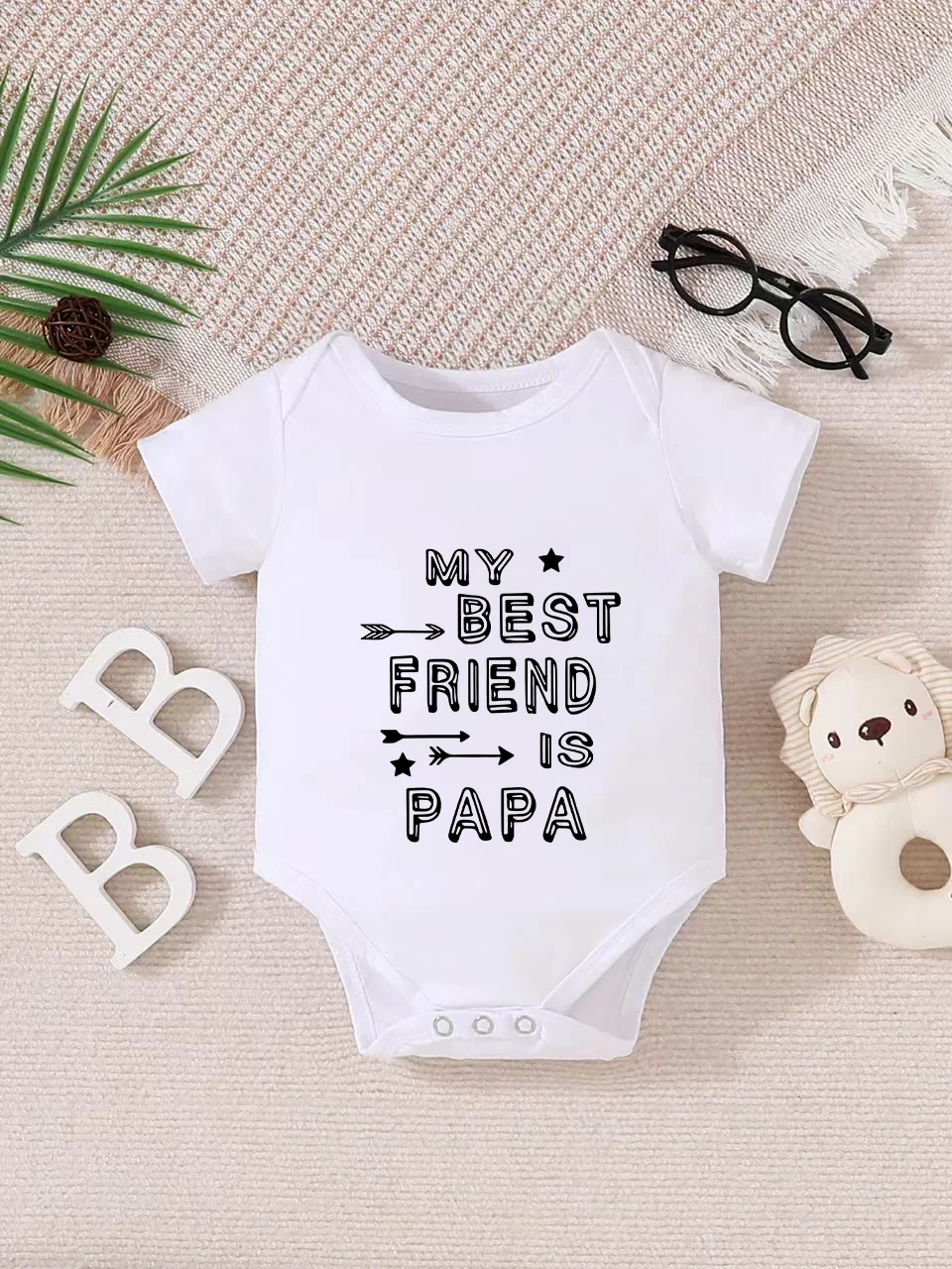 Playful letter-printed baby short-sleeve triangle bodysuit. Button closure for easy dressing, machine washable