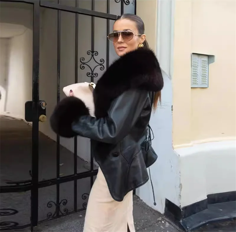 เสื้อแจ็คเก็ตผู้หญิง คอลเลคชั่นฤดูใบไม้ร่วง 2025 สไตล์ใหม่ สีดำ แขนยาว แต่งปกขนเฟอร์ขนาดใหญ่ หนังเทียม พร้อมเข็มขัดรัดเอว