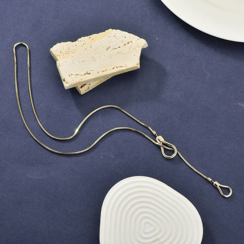 

A woman pulling out a geometric multi-functional long necklace, a personalized and fashionable sweater chain