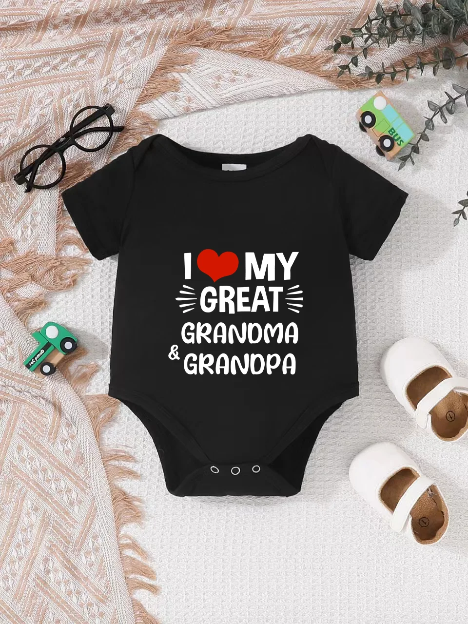 Playful letter-printed baby short-sleeve triangle bodysuit. Button closure for easy dressing
