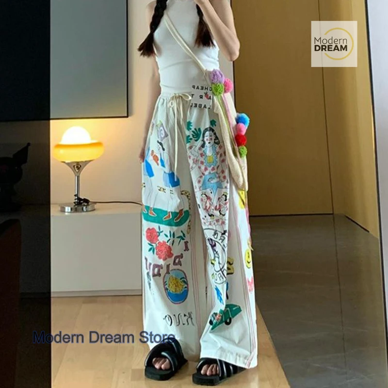 Korean version of simple minority cartoon graffiti printed pants women's summer new plus size design high waist casual pants.