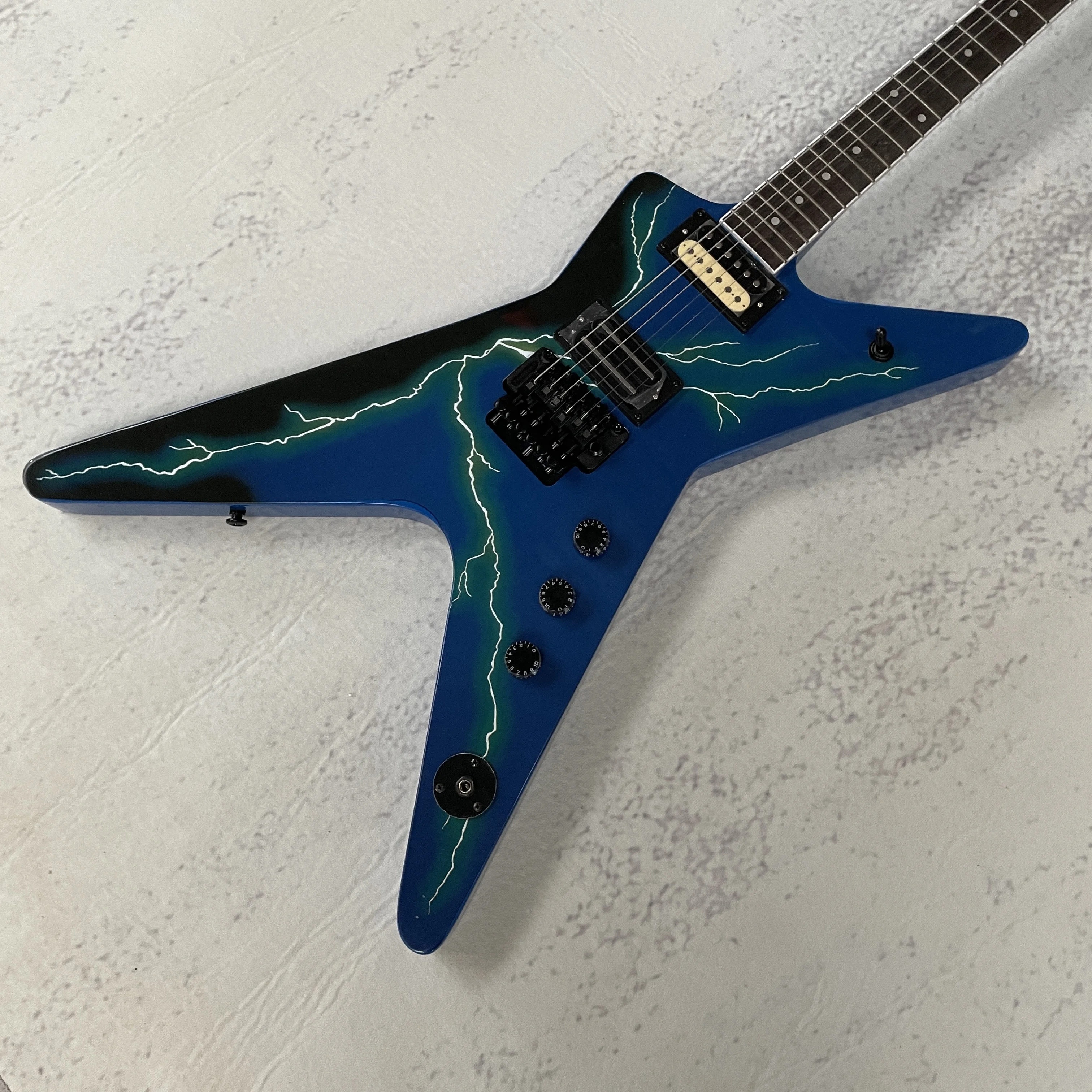 

Blue six-string electric guitar, V-shaped, high-quality tone, tremolo system