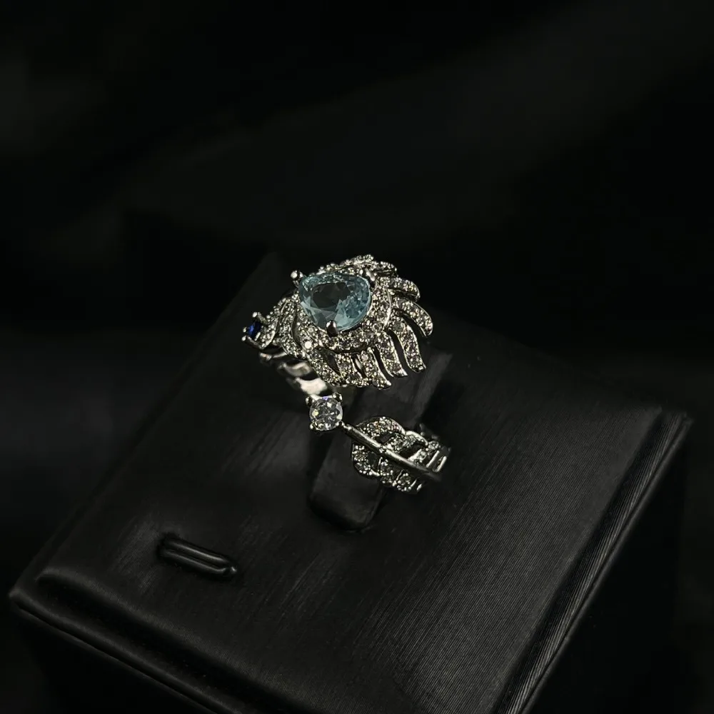 

Sky Blue Feather Ring – Gold Plated Copper Adjustable Ring for Heart Chakra Balancing & Attracting Peaceful Love