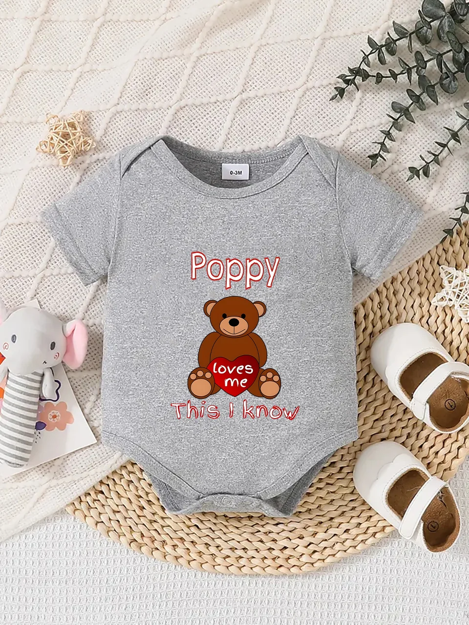 Playful letter-printed baby short-sleeve triangle bodysuit. Button closure for easy dressing, machine washable