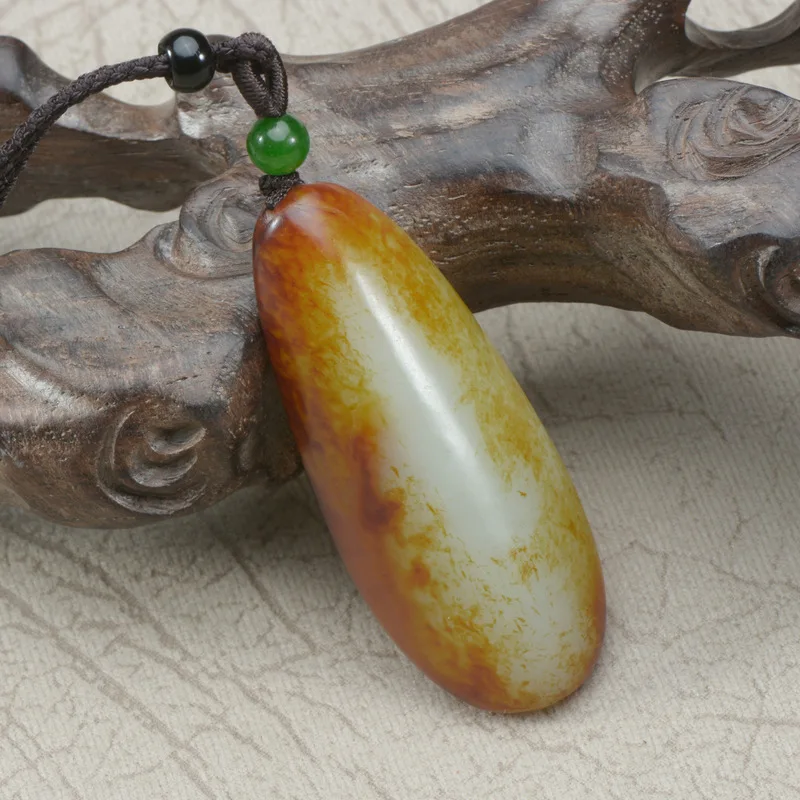 Xinjiang Hotan jade raw stone with yellow-red translucent skin, unshaped hand-held piece