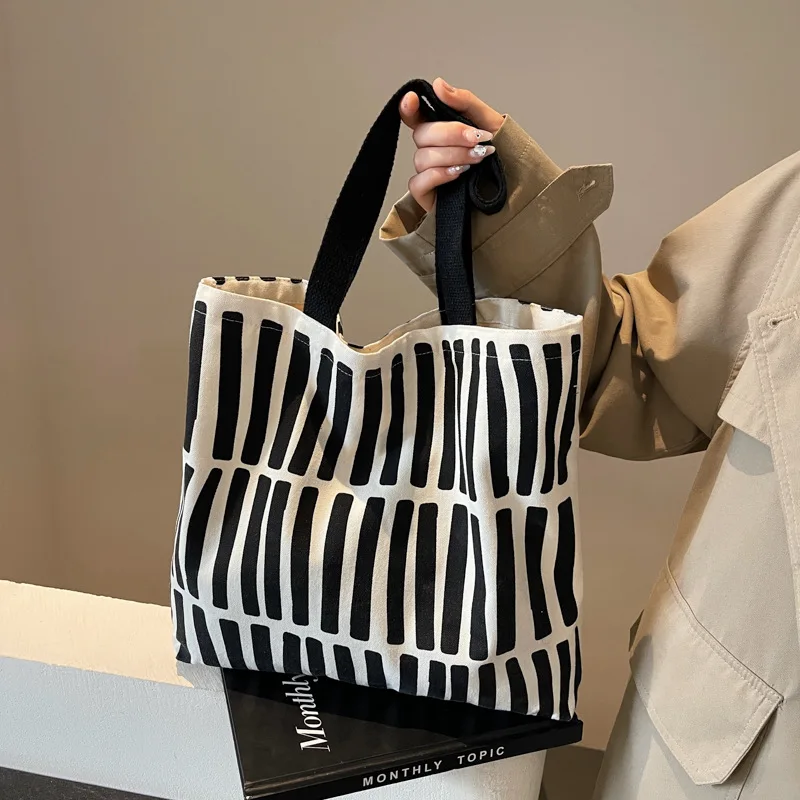 ファッションプリントストライプキャンバスバッグ、大容量裏地ハンドバッグ、キャンパス学生バックパック、若者の日常ショッピング文学用途