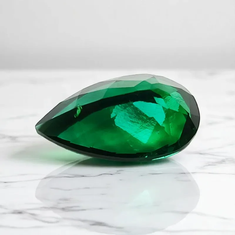 

Lab Grown Zambian Emerald Pear Shape Hydrothermal Hand Cutting Cut with Cracks Inclusions Inside Selectable AGL Certificate