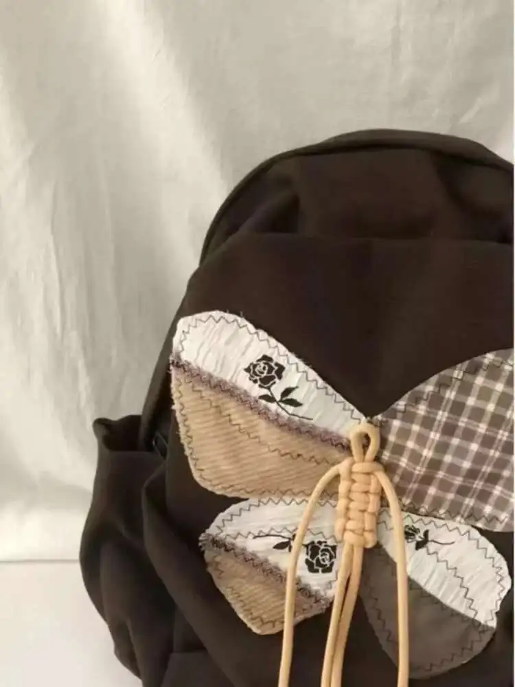 2025 ใหม่ Patchwork ผีเสื้อกระเป๋านักเรียนกระเป๋าเป้สะพายหลังไหล่กระเป๋านักเรียนวัยรุ่นของขวัญ B1979 hit