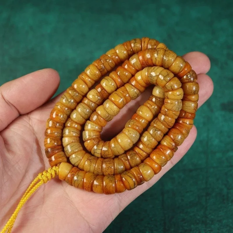 Yak bone with patina and fissures, 108 beads in the shape of a horseshoe, long string of old ox bones