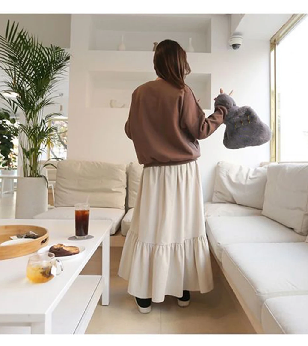 The loose, student-style, retro autumn corduroy fashion A-line all-in-one mid-calf apricot aesthetic skirt from Harajuku