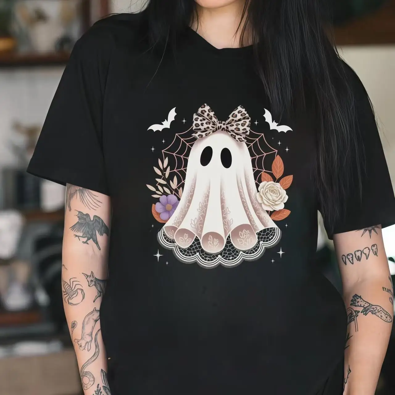 

"Cute Ghost Halloween Graphic Tee | Spooky Floral Bat Print T-Shirt with Bow Design | Casual Black Fall Top"