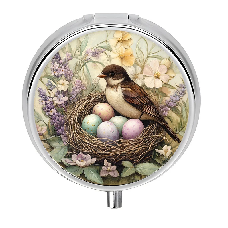 A portable pill box with a three-compartment design, featuring a spring bird theme, perfect for organizing vitamins in a purse or handbag. This metal mini storage box is perfect for travel and office use
