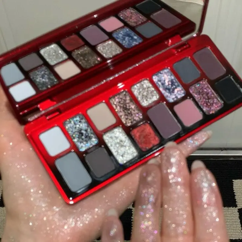 Eine gotische kleine rauchige rote und schwarze Lidschattenpalette, eine dunkle, nische, super coole und stilvolle Eyeliner