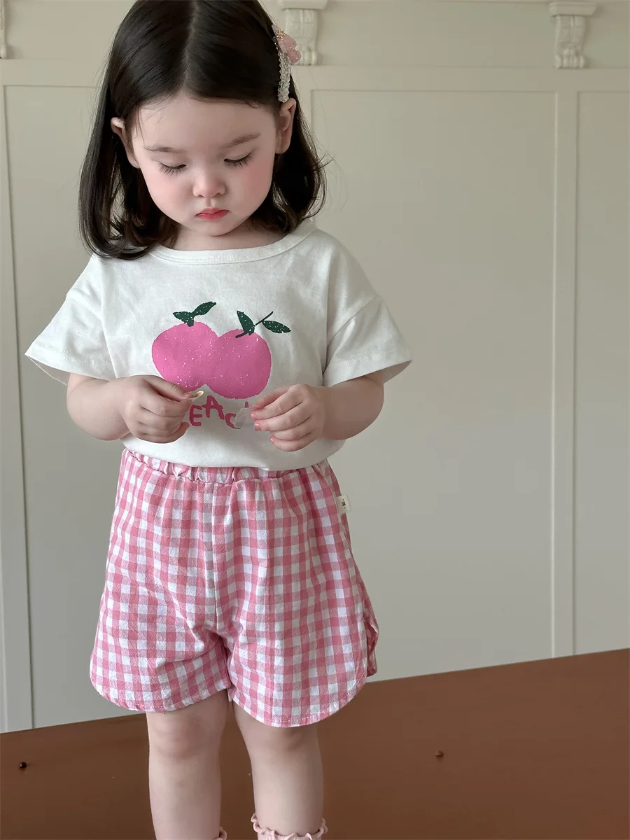 NOVEDAD DE VERANO 2025, camisetas de manga corta con estampado de frutas para niña, conjunto informal, pantalones cortos finos a cuadros para niño, traje de 2 uds, trajes de algodón para niño