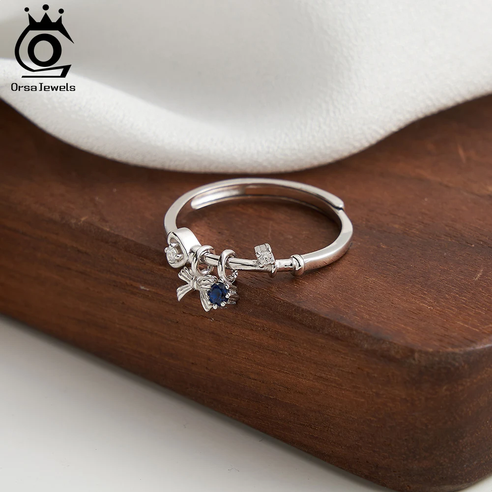 ORSA JEWELS Anillo con colgante de lazo de circonia cúbica de Plata de Ley 925, colgante redondo azul de zafiro de oro de 14 quilates, anillo abierto con ajuste de punta, regalo SR336