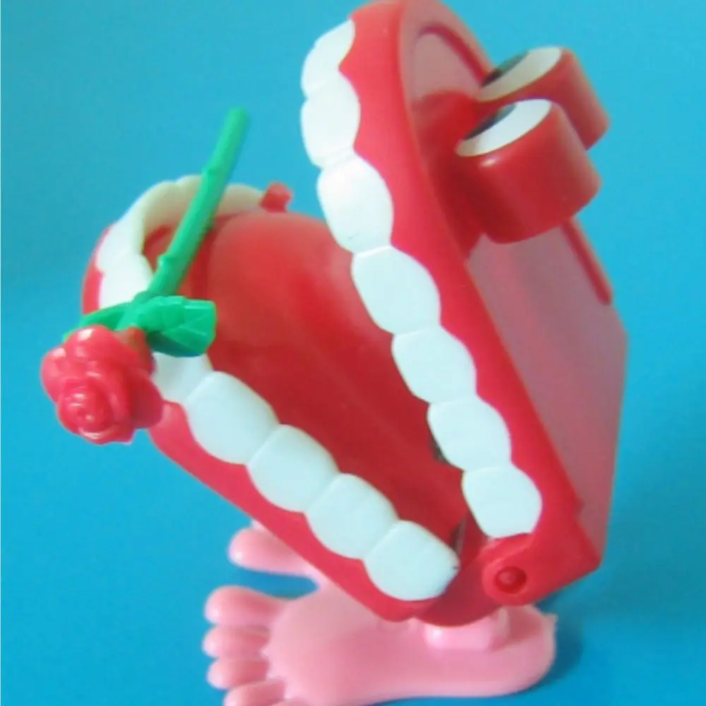 Mini plastica per bambini piccoli Denti per protesi per bambini Giocattolo a orologeria rosa Giocattolo a orologeria a carica a forma di denti da passeggio