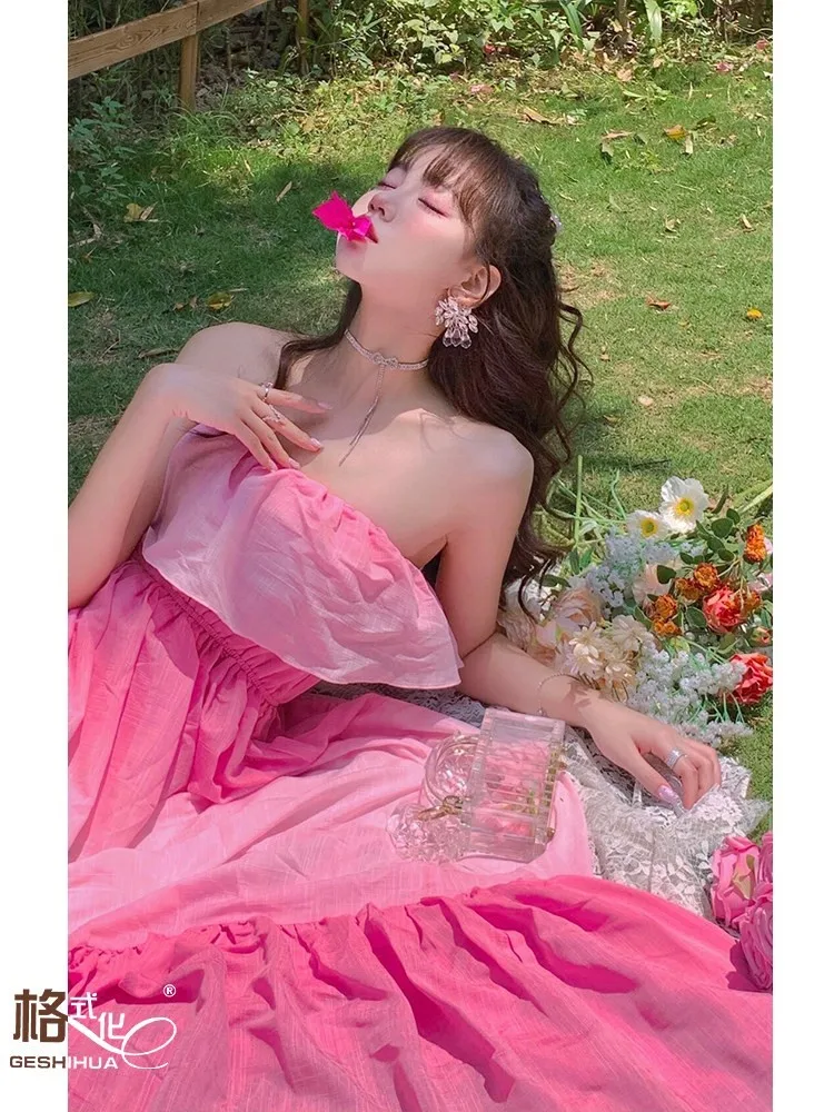 A unique strapless dress with pink gradient and one-shoulder ruffled edges