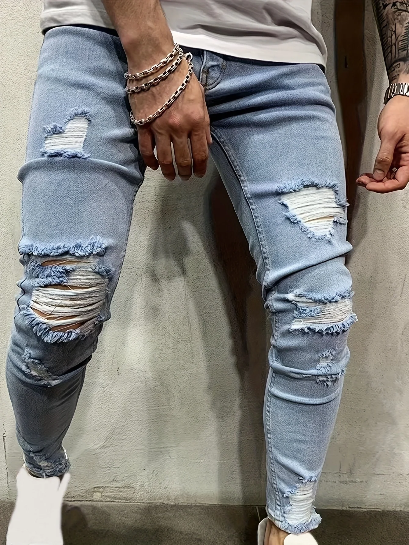 Men's Stretch Slim-fit Ripped Jeans, Featuring a Fashionable Street Style. These Blue Urban-style Jeans Are Versatile for Casual Outings, Leisure Activities, and Work. They Are Classic Blue Stretch Jeans with a Washed Finish and a Tapered Leg Design