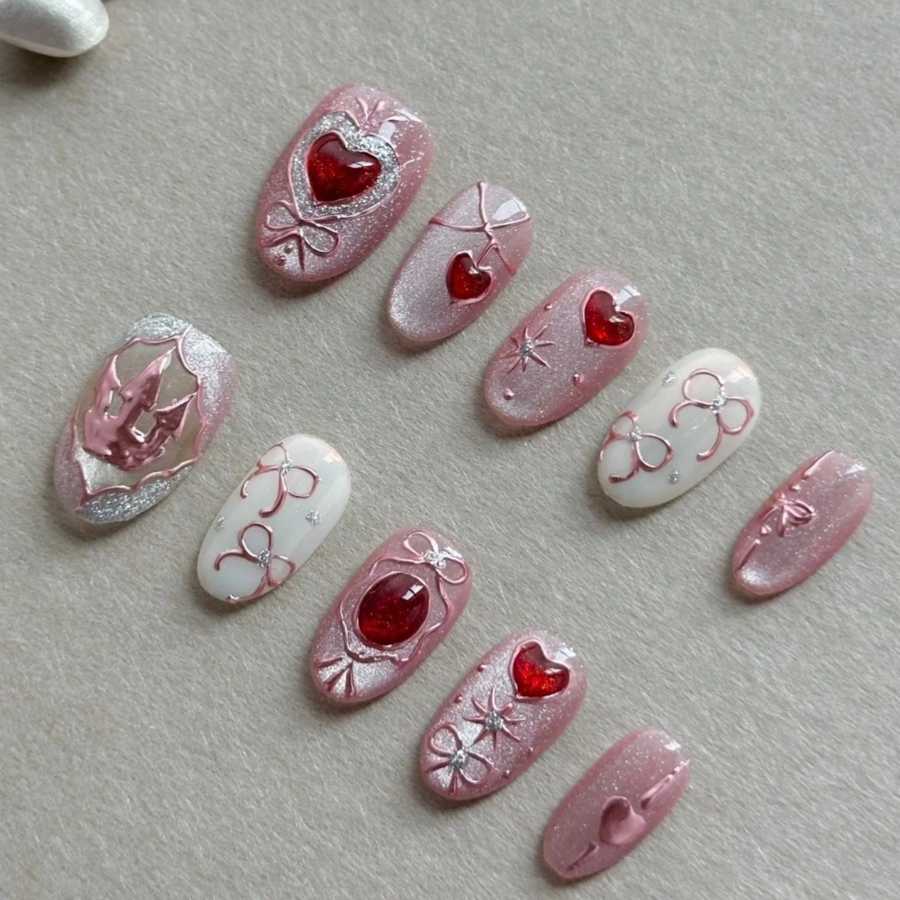Ten Elegantly Hand-Pressed Oval False Nails, Featuring a Charming Pink-and-White 3D Heart Design, Perfect for Ladies.