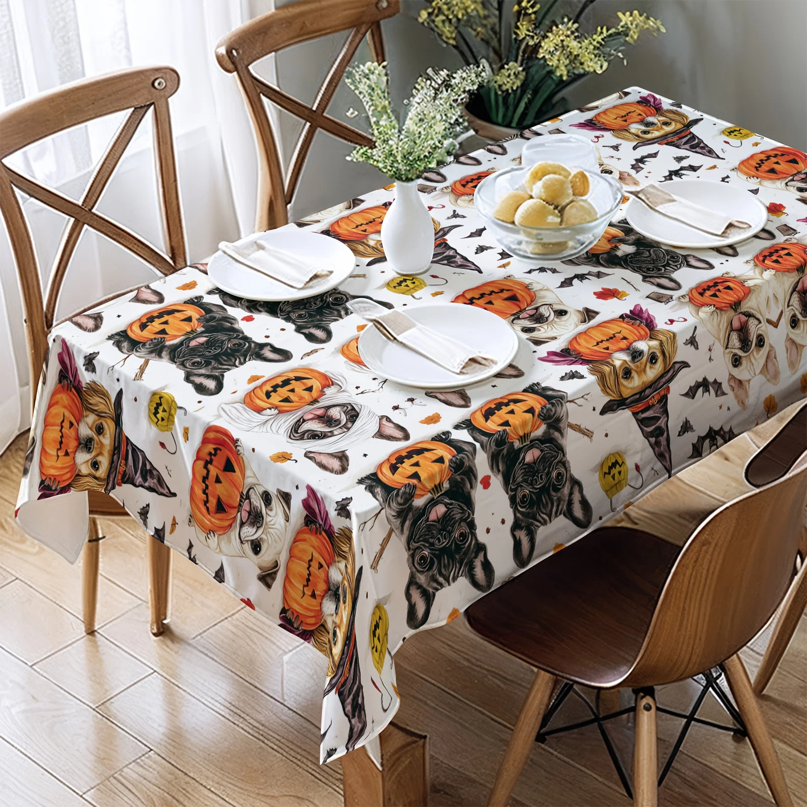 One Halloween tablecloth with a pattern featuring black and white spotted dogs and pumpkin lanterns -